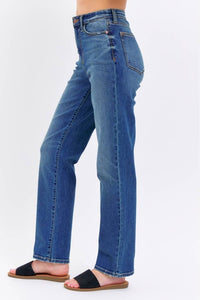 Blue jeans worn by a person on a white background