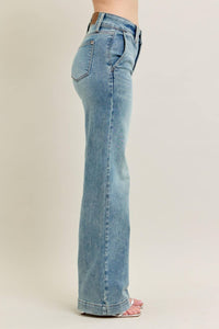 Light blue jeans worn by a person on a beige background