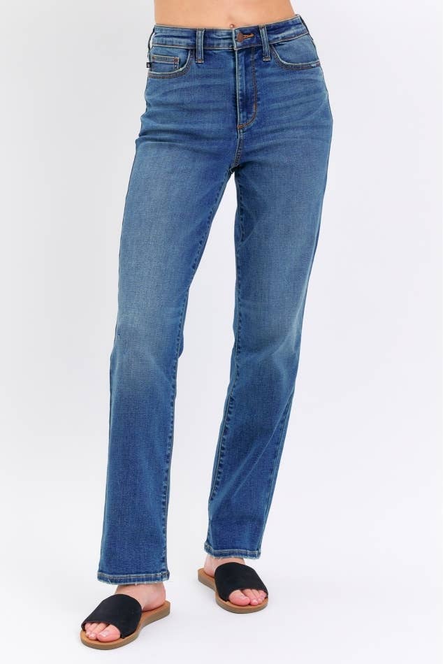 Blue jeans worn by a person on a white background