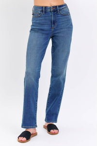Blue jeans worn by a person on a white background