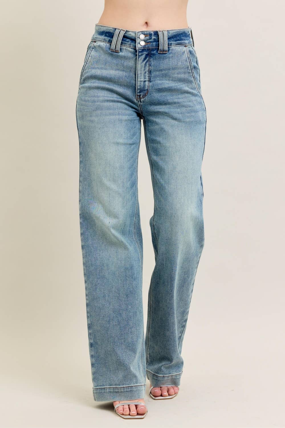 Light blue jeans on a beige background