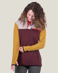 Woman wearing a colorful pullover with a neutral background