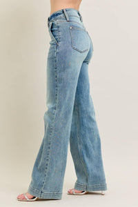 Light blue jeans worn by a person on a plain background