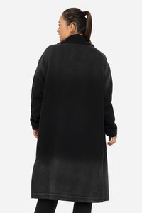 Person wearing a black coat on a white background