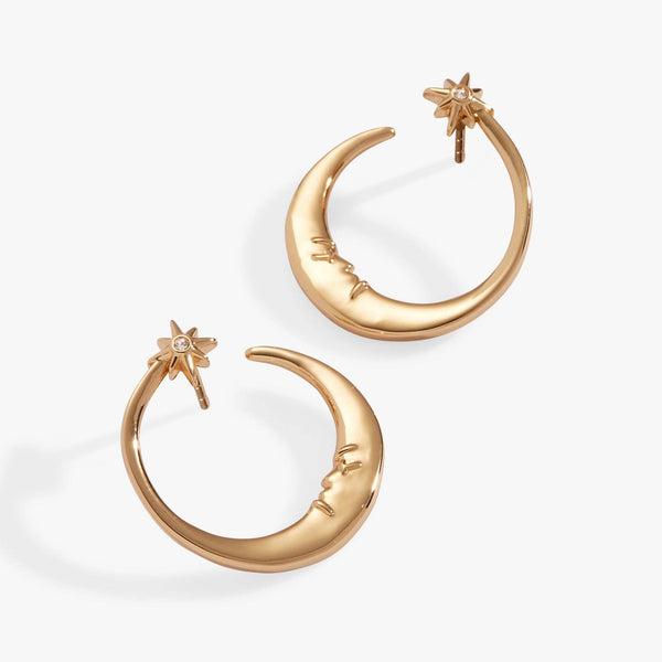 Gold hoop earrings with star and moon designs on a white background