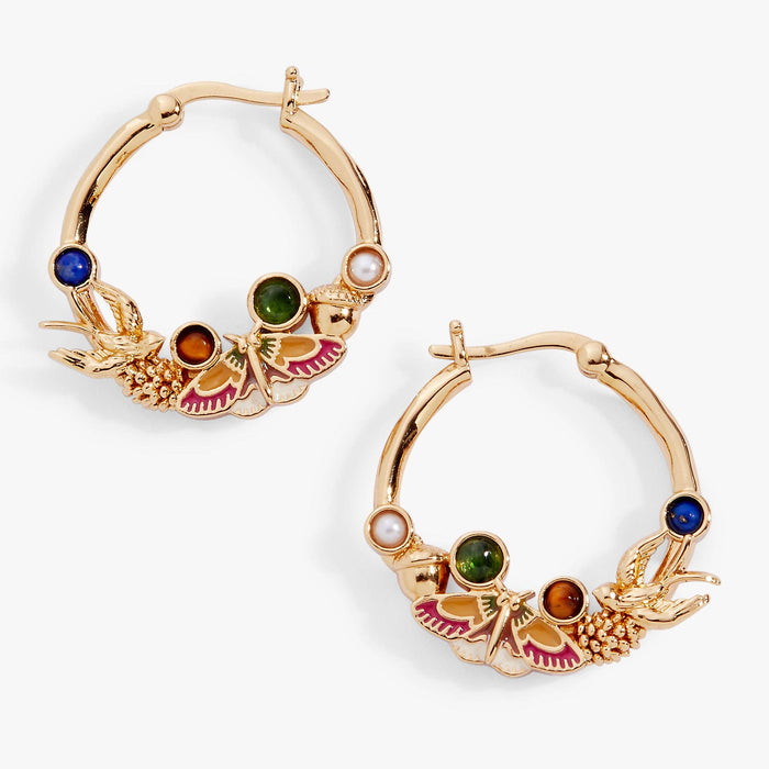 Gold hoop earrings with colorful gemstones on a white background