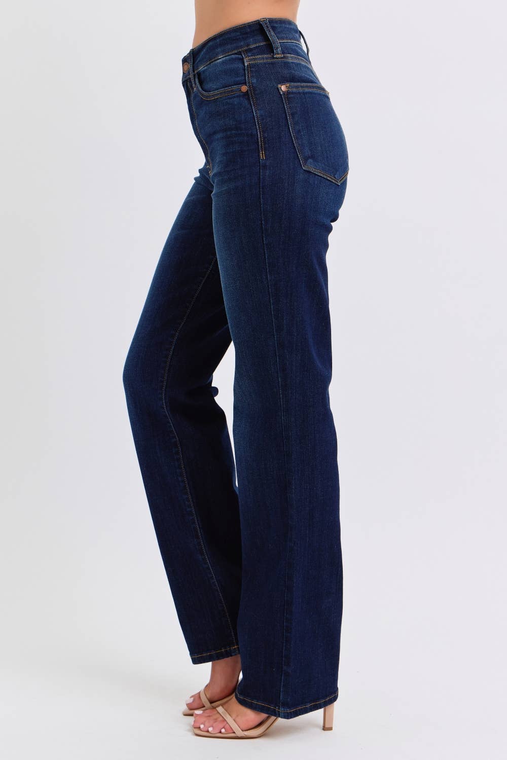 Blue jeans worn by a person on a white background