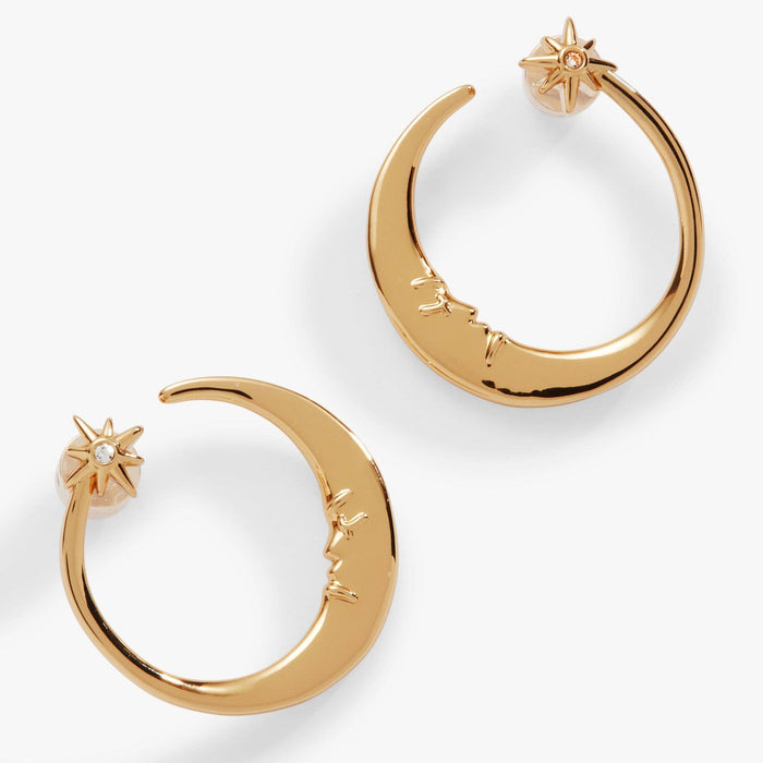 Gold hoop earrings with star and moon designs on a white background