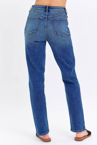 Blue jeans worn by a person on a white background