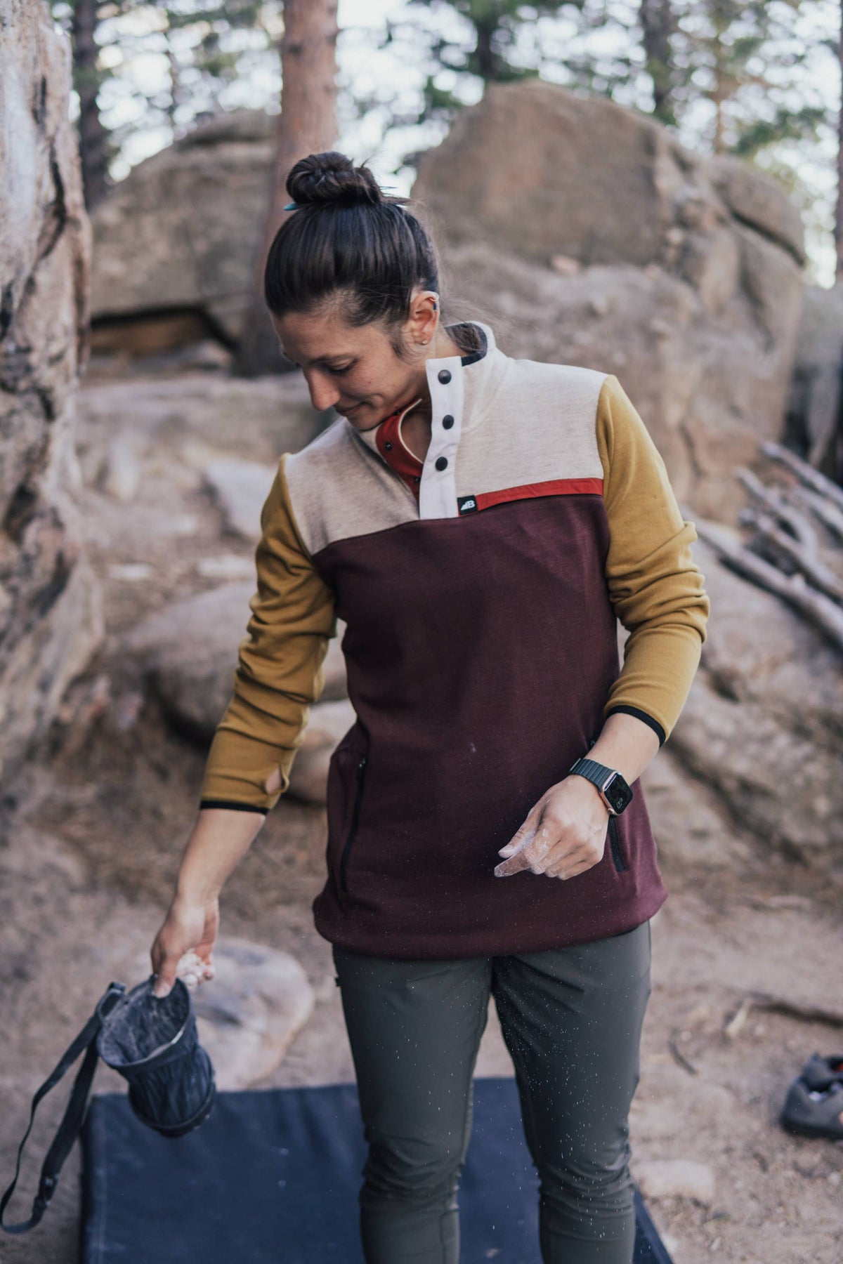 Person wearing a two-tone jacket in a natural setting