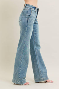 Light blue jeans worn by a person on a beige background