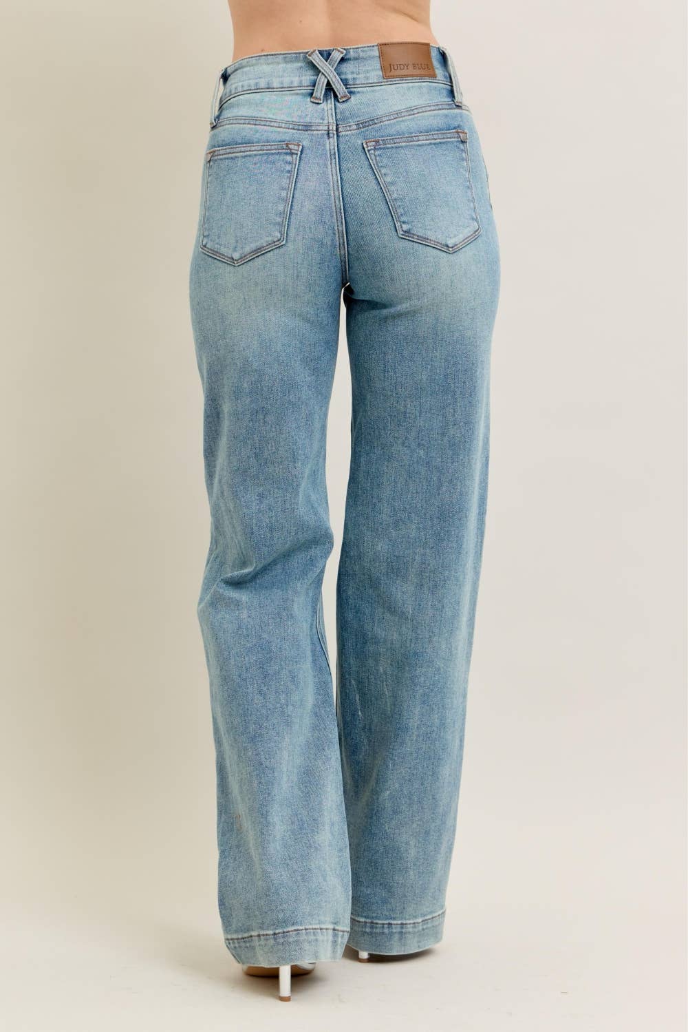 Light blue jeans on a beige background