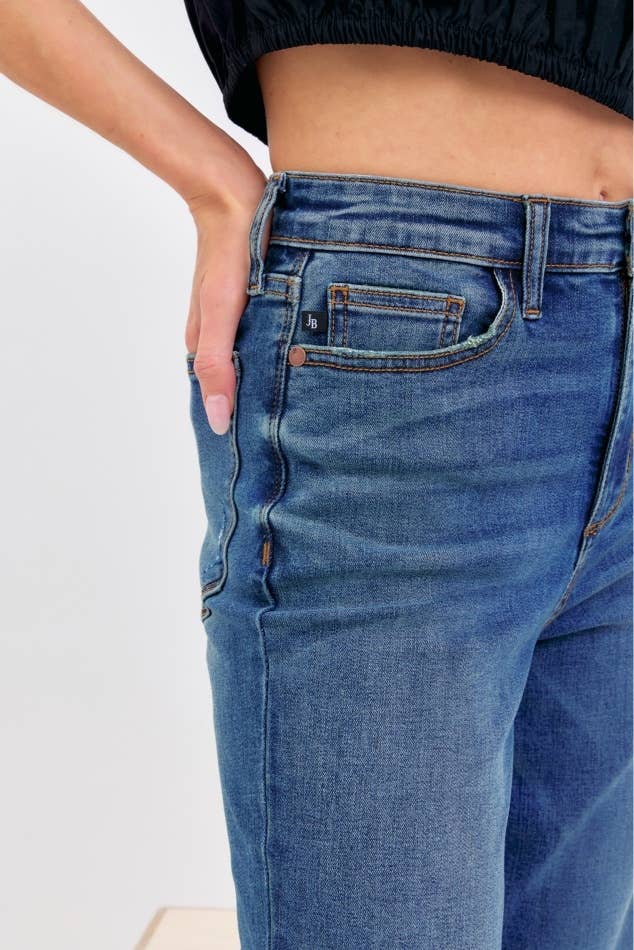 Close-up of blue jeans with a plain background