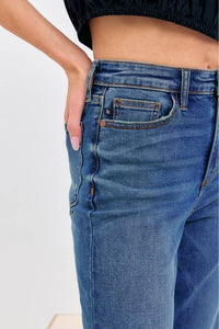 Close-up of blue jeans with a plain background
