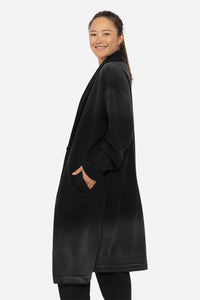 Woman wearing a black coat on a white background