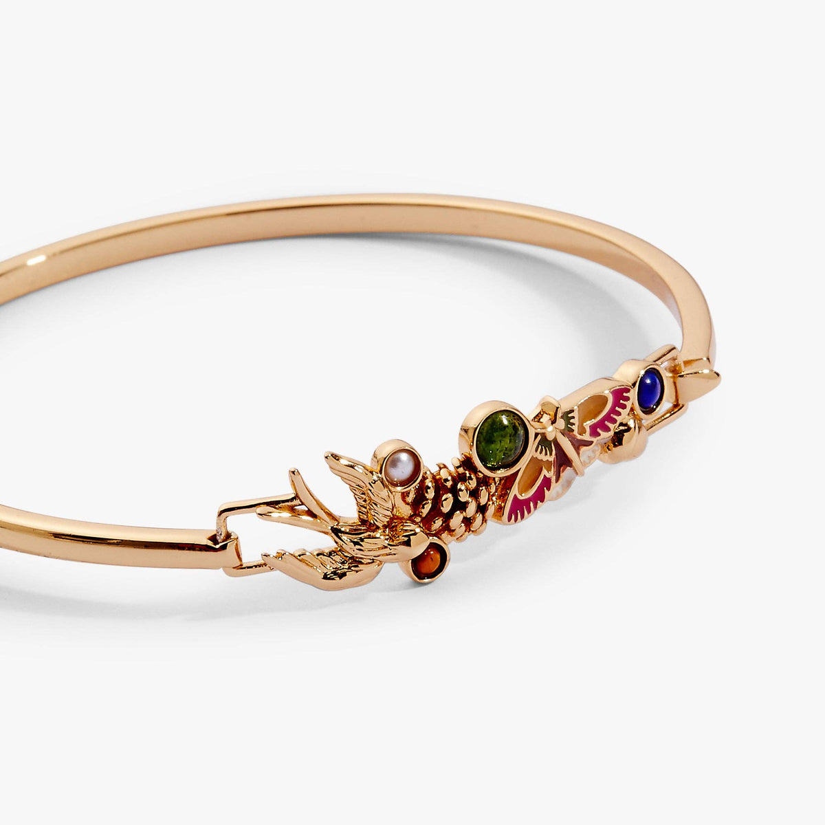 Gold bracelet with gemstone accents on a white background