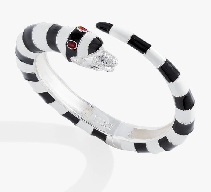 Black and white striped bracelet with a red gemstone on a white background