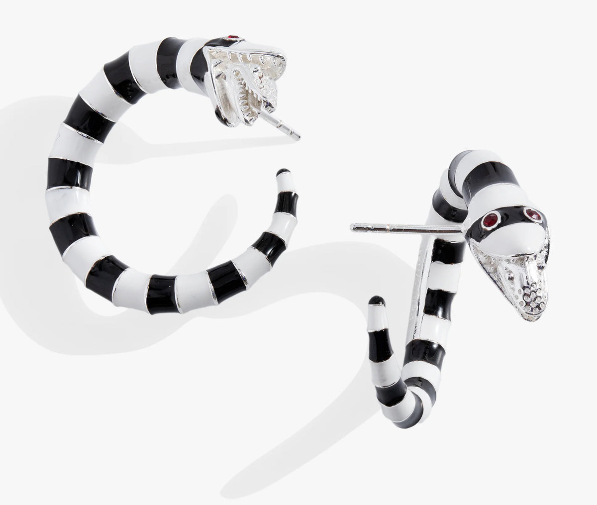 Black and white striped snake-shaped earrings on a white background