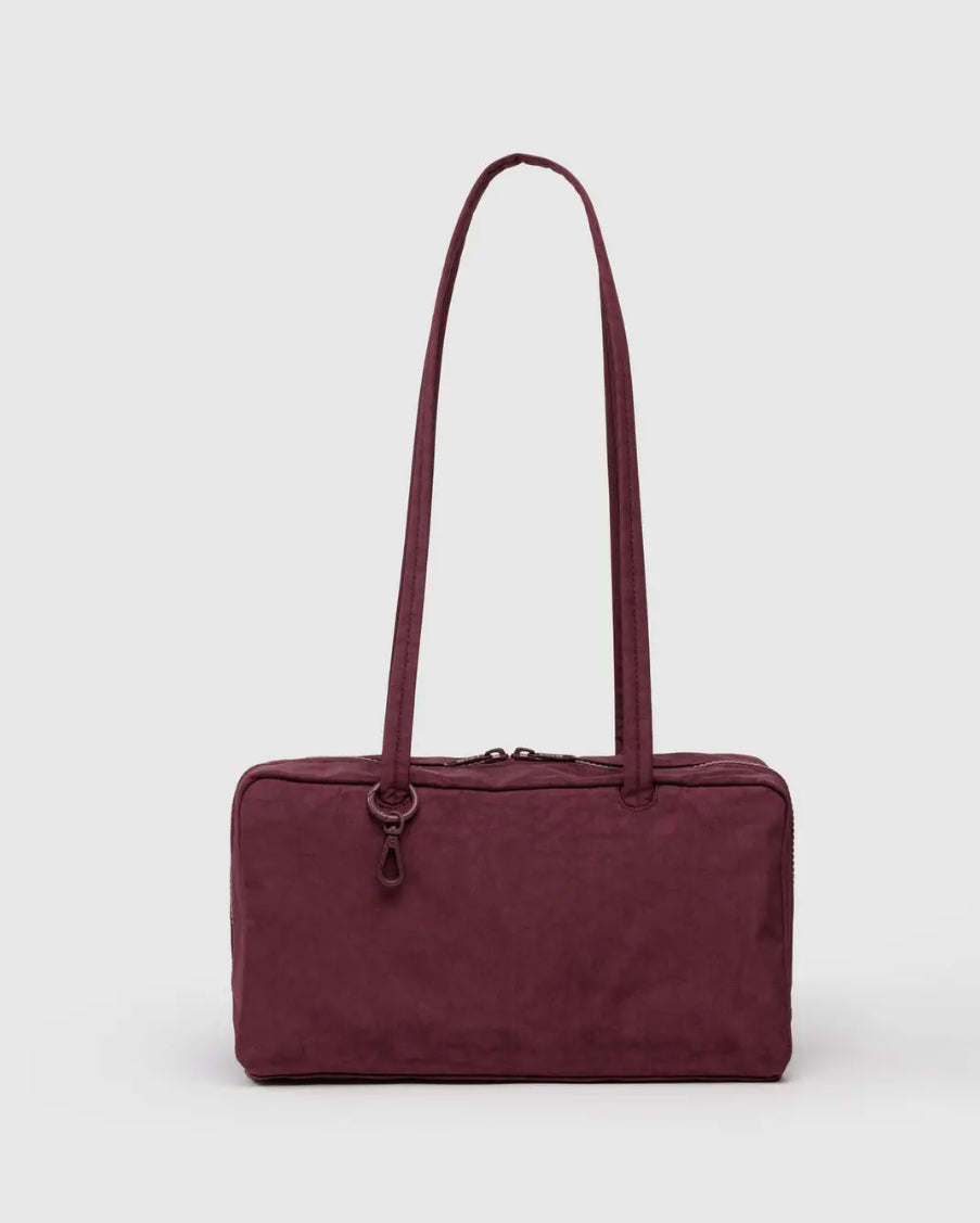 Maroon handbag with a strap on a white background