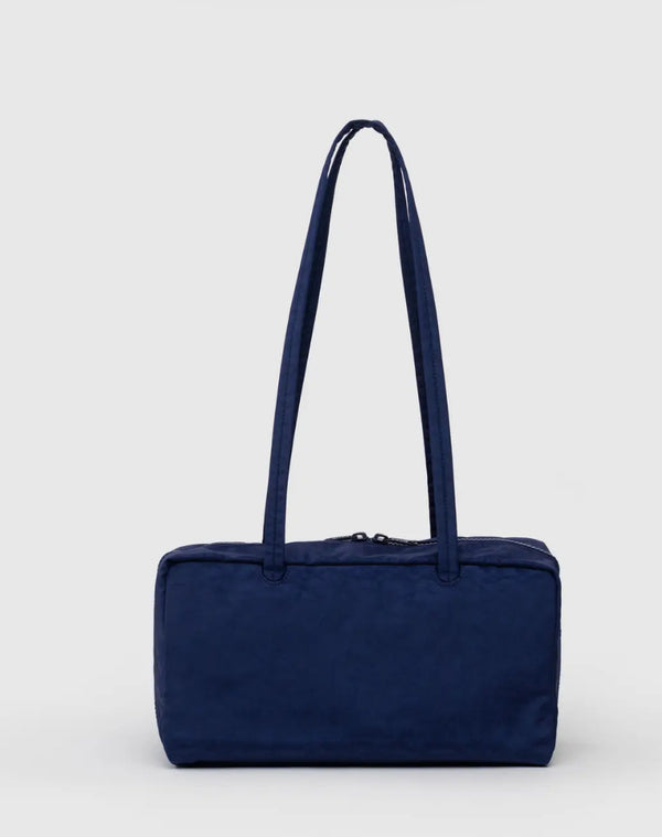 Navy blue handbag on a light gray background