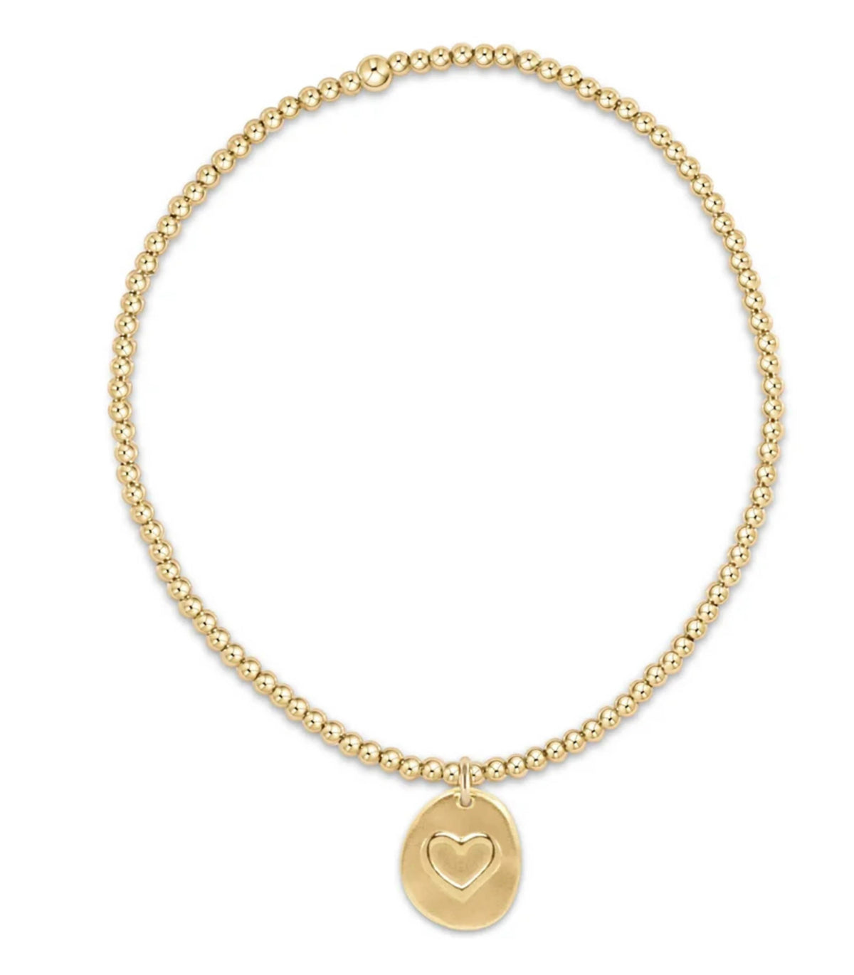 Gold beaded bracelet with a heart-shaped charm on a white background