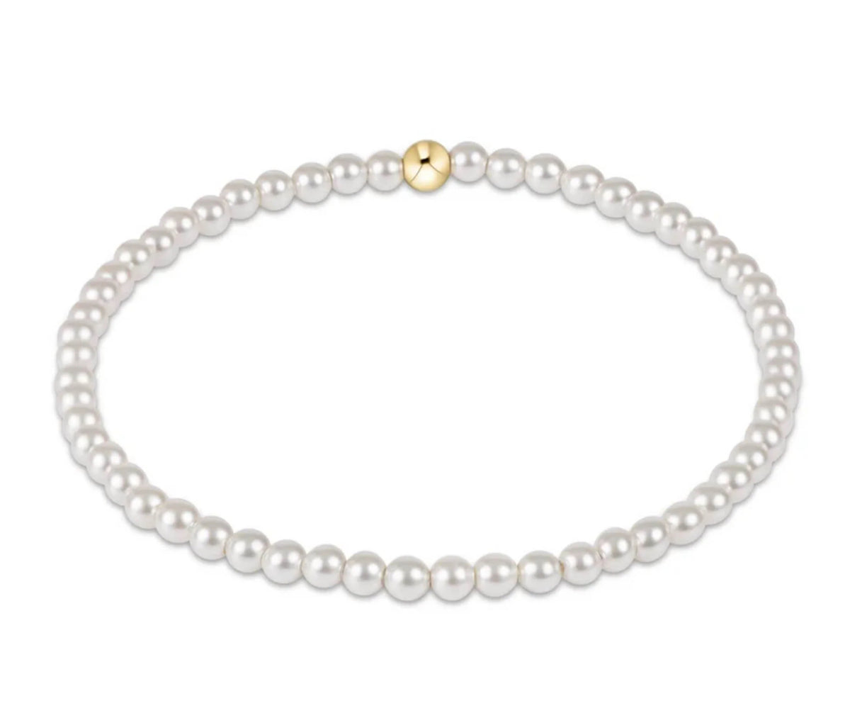 Pearl bracelet with a gold clasp on a white background