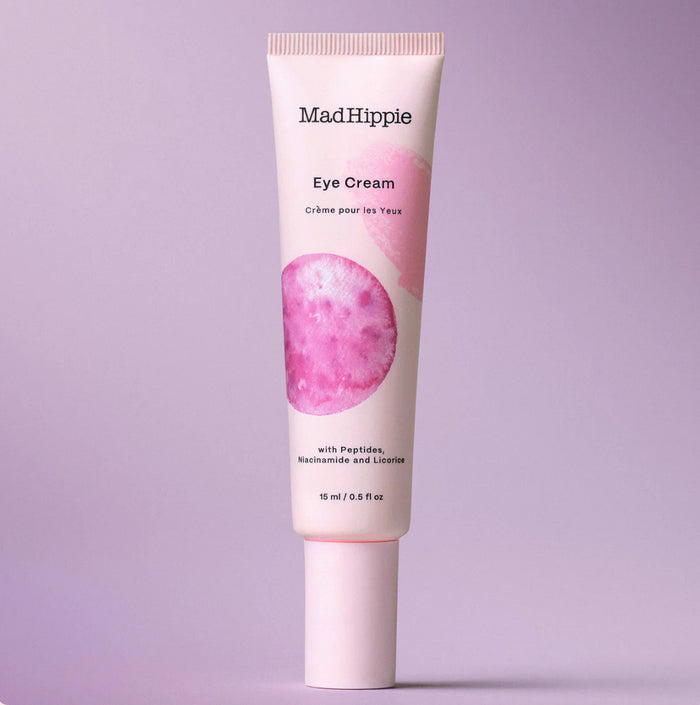 Mad Hippie Eye Cream tube on a light purple background