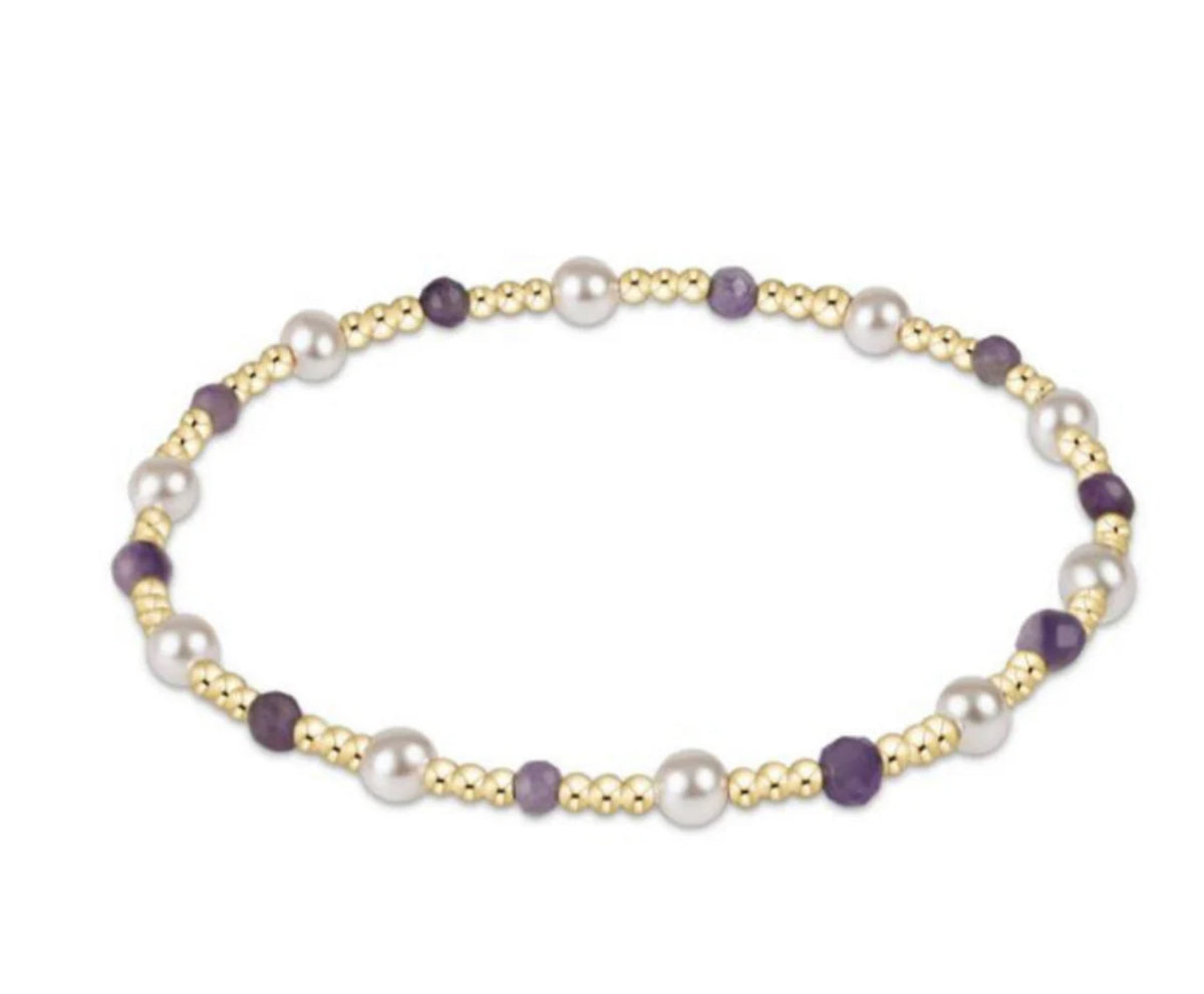 Bracelet with pearls and gold beads on a white background