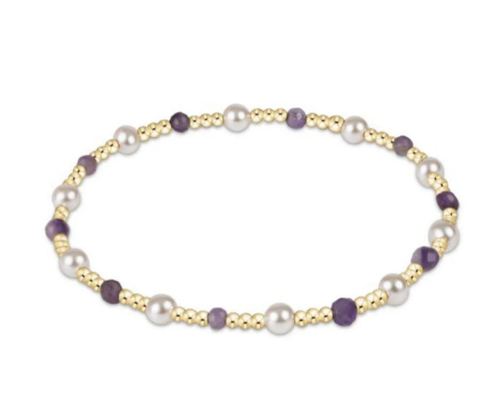 Bracelet with pearls and gold beads on a white background