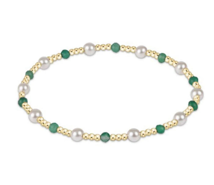 Necklace with pearls and green beads on a white background