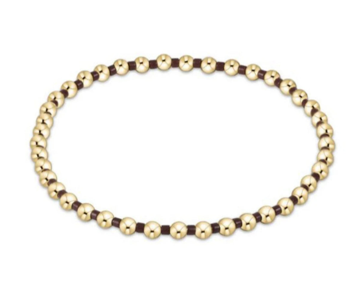 Gold beaded necklace on a white background