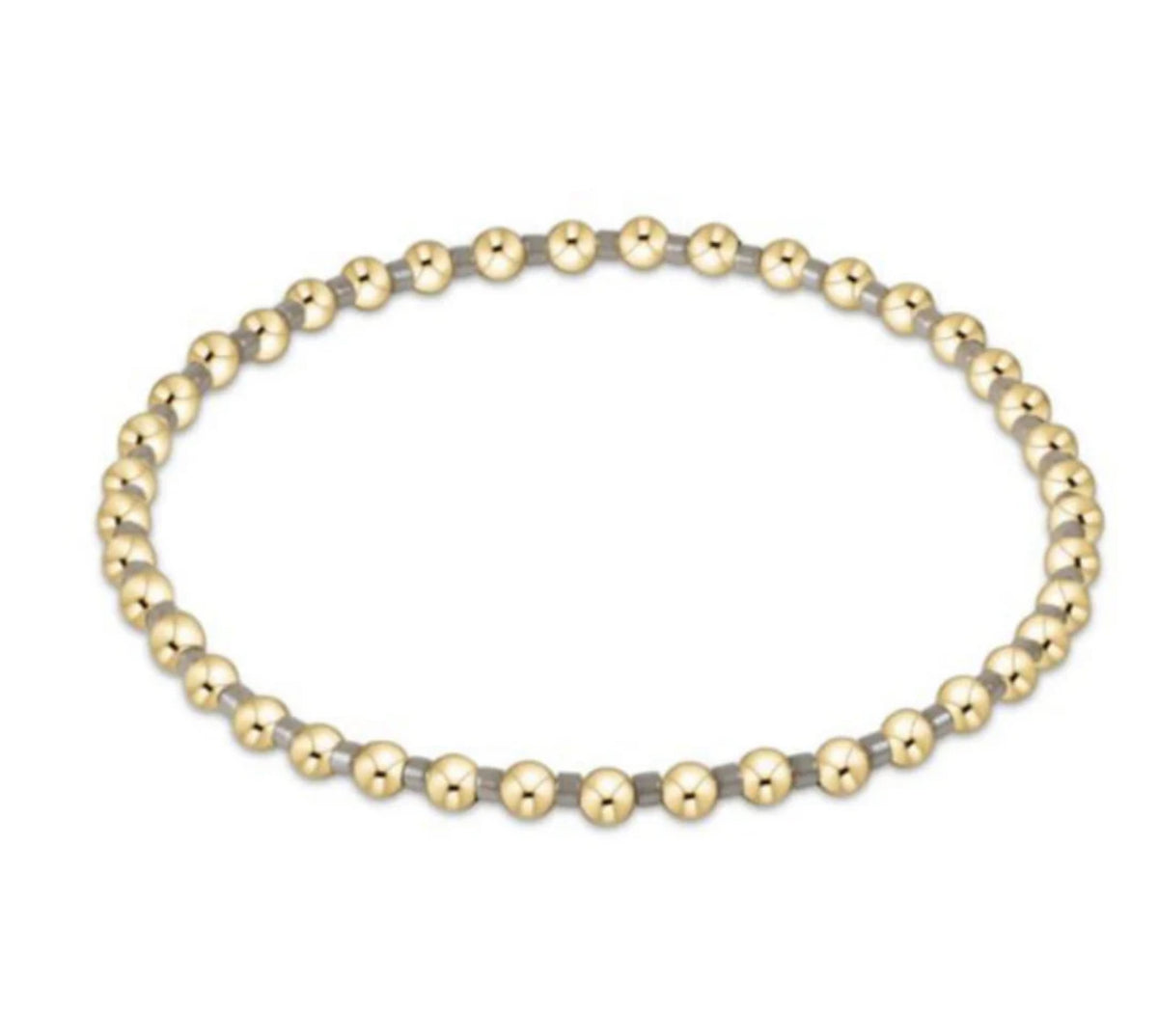 Gold and silver beaded necklace on a white background