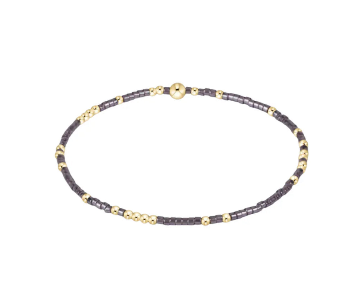 Necklace with black and gold beads on a white background