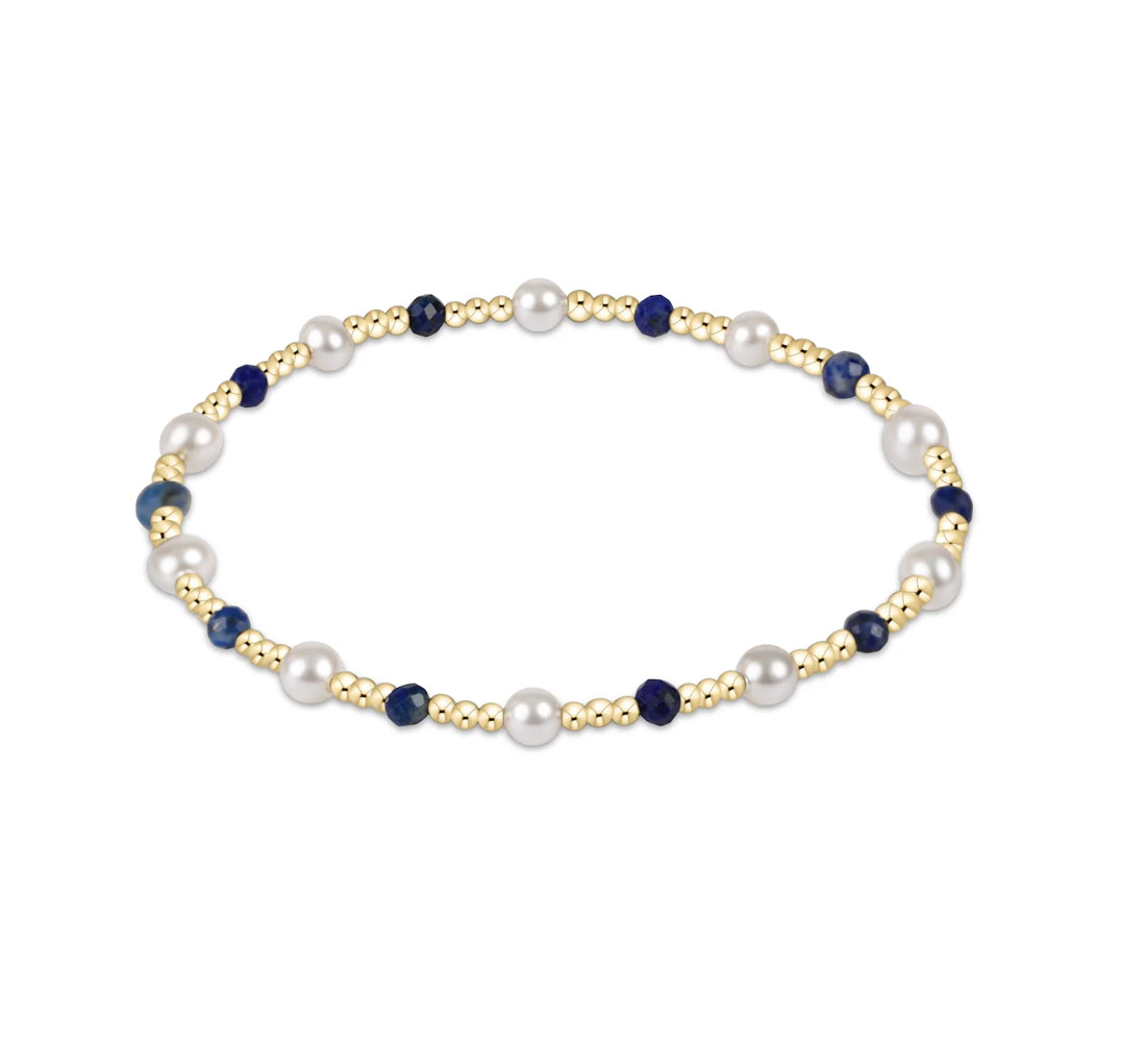 Pearl and blue bead necklace on a white background