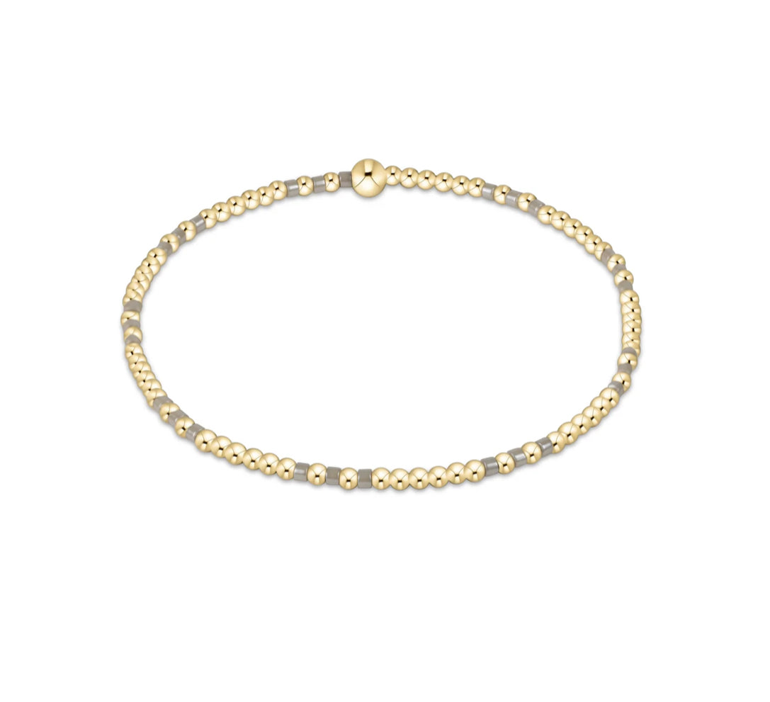 Gold beaded necklace on a white background