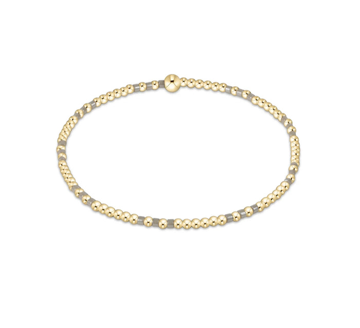 Gold beaded necklace on a white background
