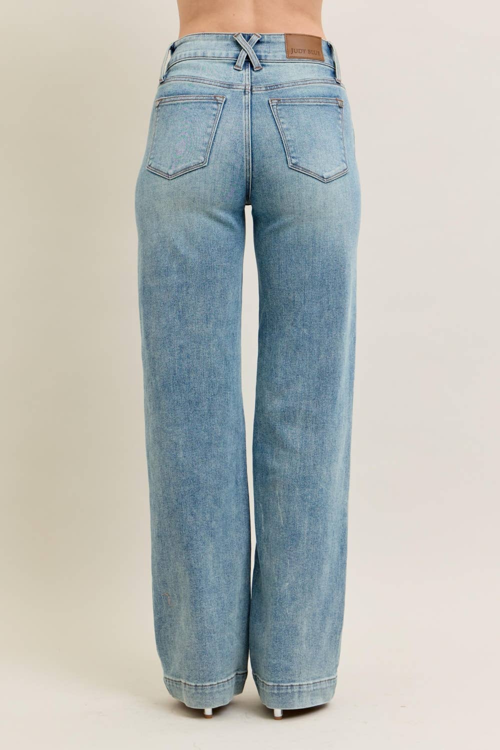 Light blue jeans on a beige background