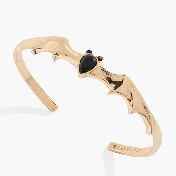 Gold bracelet with black stones on a white background