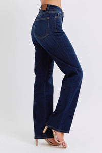 Blue jeans worn by a person on a white background