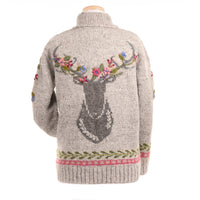 Knitted sweater with deer design and floral details on a white background