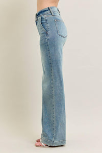 Light blue jeans worn by a person on a plain background