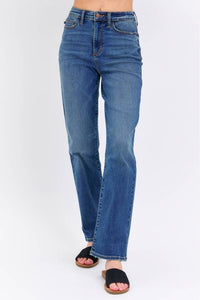 Blue jeans worn by a person on a white background